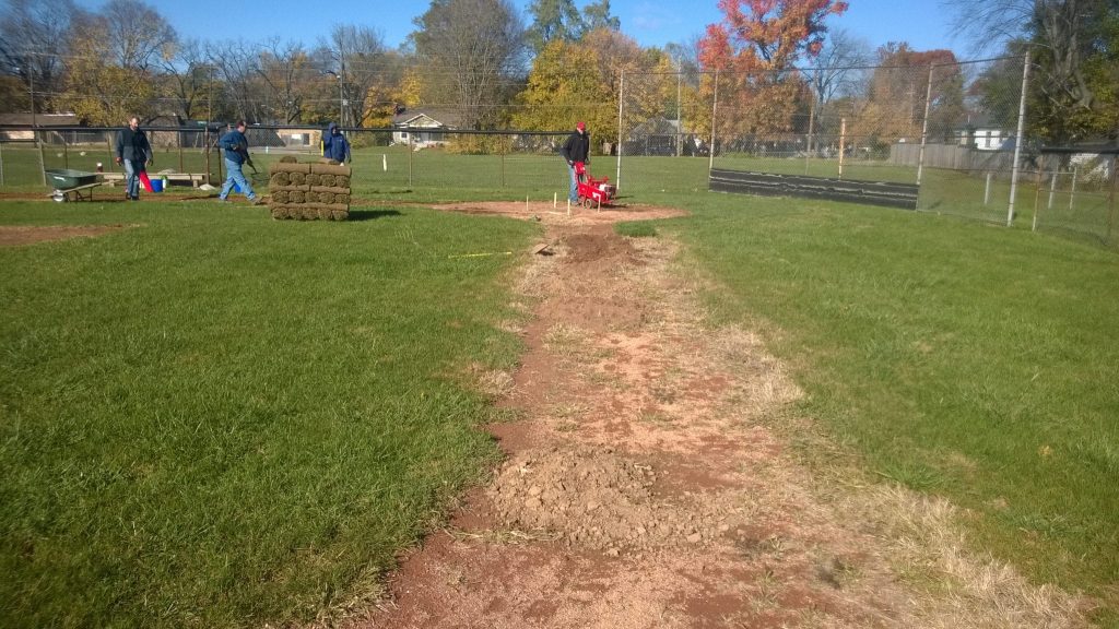 ats team working on baseball field 