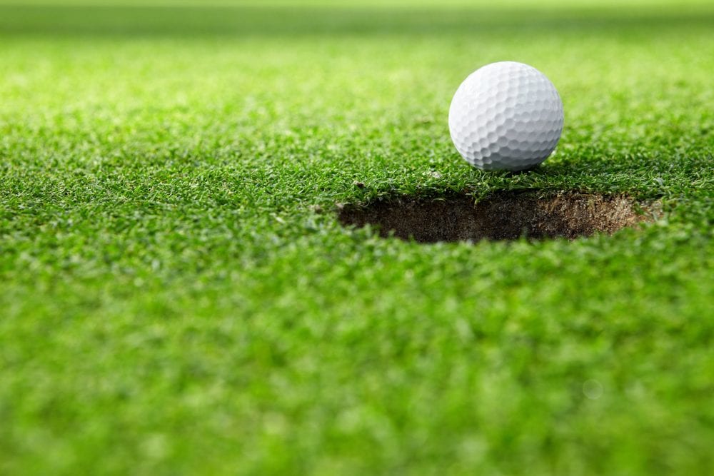 close-up of golf ball at the hole