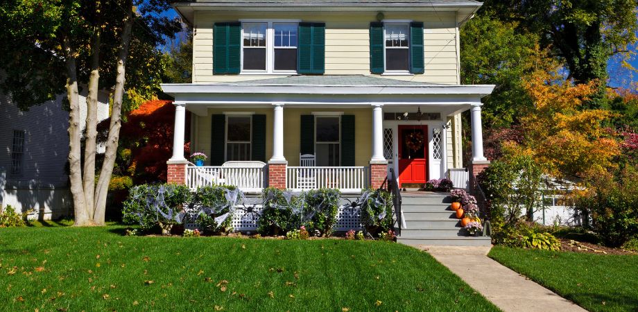 Home in residential area with Halloween decorations on lawn